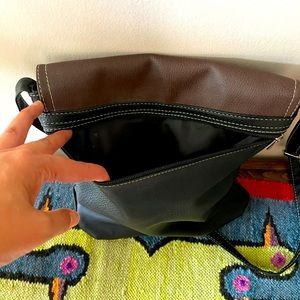 100% leather black with brown crossbody bag.